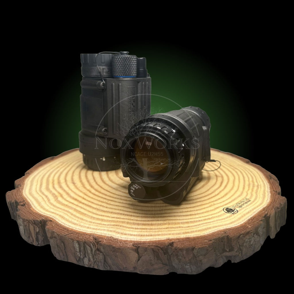 Night vision monoculars built in the UK, with NNVT or Photonis tubes. Displaying the ocular side with a black background on a wooden pedestal.