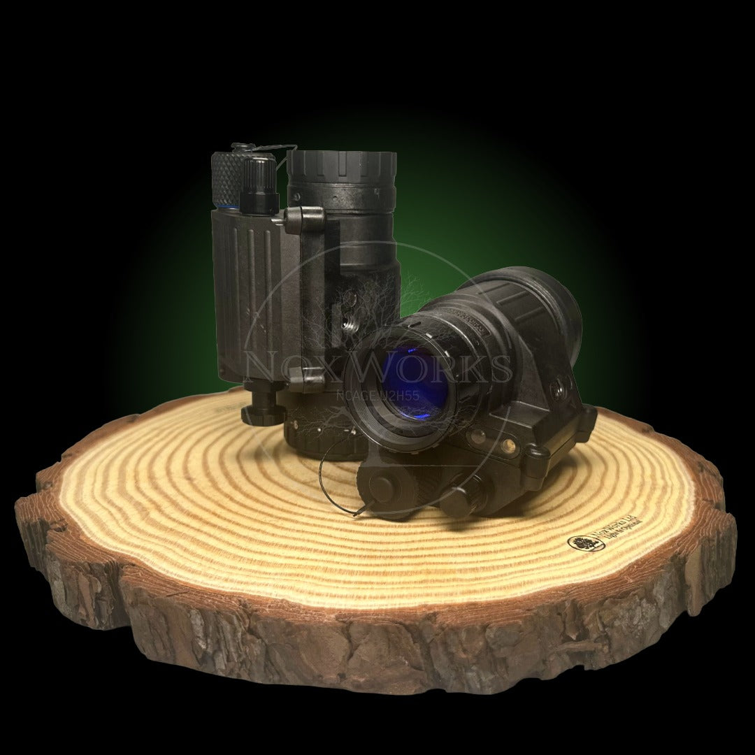 Night vision monoculars built in the UK, with NNVT or Photonis tubes. Displayed on a black background on a wooden pedestal.